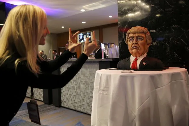 A supporter takes a picture of a cake in the form of Republican U.S. presidential nominee Donald Trump at election night rally in Manhattan, New York, U.S., November 8, 2016. (Photo by Jonathan Ernst/Reuters)