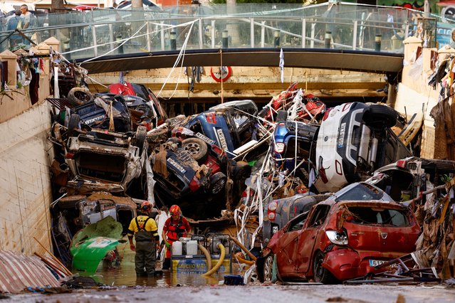 Firefighters pump out the floodwater out of a tunnel where vehicles are piled up, after heavy rains in Alfafar, in Valencia, Spain on November 1, 2024. (Photo by Susana Vera/Reuters)