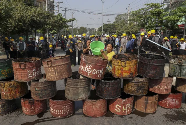 People build barricades to deter security personnel from entering a protest area in Mandalay, Myanmar, Thursday, March 4, 2021. Demonstrators in Myanmar protesting last month's military coup returned to the streets Thursday, undaunted by the killing of at least 38 people the previous day by security forces. (Photo by AP Photo/Stringer)