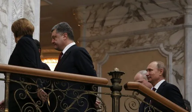 German Chancellor Angela Merkel walks with French President Francois Hollande (covered), Ukraininan President Petro Poroshenko, followed by Belarussian President Alexander Lukashenko and Russian President Vladimir Putin (L-R) after a meeting in Minsk, February 11, 2015. (Photo by Grigory Dukor/Reuters)