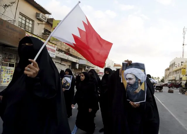 Protesters holding posters of Saudi Shi'ite cleric Nimr al-Nimr and a Bahraini national flag protest against his execution by Saudi authorities in the village of Sanabis, west of Manama, Bahrain January 3, 2016. (Photo by Hamad I. Mohammed/Reuters)