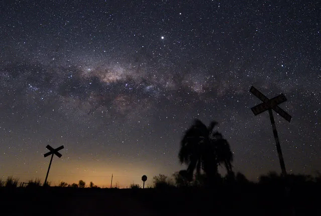 The Milky Way's Galactic Centre and Jupiter (brightest spot at centre top) are seen from the countryside near the small town of Reboledo, department of Florida, Uruguay, early on August 24, 2020. (Photo by Mariana Suarez/AFP Photo)