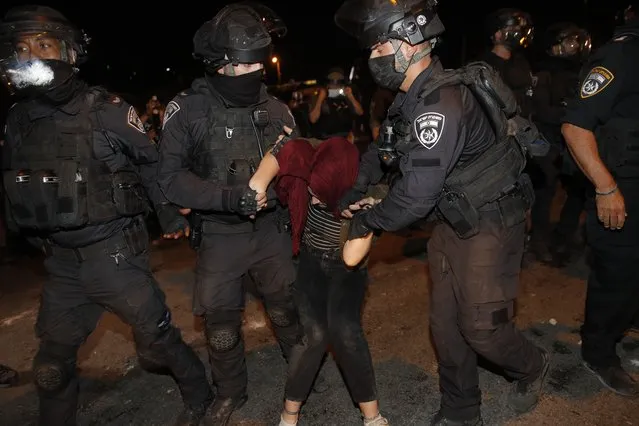 Israeli police officers detain a Palestinian demonstrator during a protest against the planned evictions of Palestinian families in the Sheikh Jarrah neighborhood of east Jerusalem, Saturday, May 8, 2021. (Photo by Oded Balilty/AP Photo)