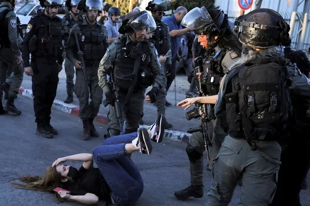 Israeli police scuffle with protesters in the Sheikh Jarrah neighborhood of east Jerusalem Saturday, May 15, 2021. The tensions began in east Jerusalem earlier this month, when Palestinians protested attempts by settlers to forcibly evict a number of Palestinian families from their homes. (Photo by Mahmoud Illean/AP Photo)