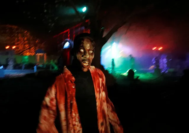 A participant in costume and make-up poses for a photo during a Halloween parade at Walibi park in Wavre, Belgium, October 31, 2018. (Photo by Yves Herman/Reuters)