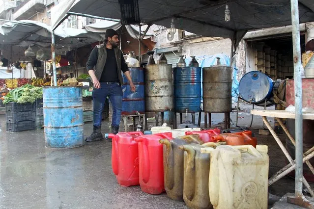 A man sells fuel in Aleppo, Syria January 19, 2016. (Photo by Abdelrahmin Ismail/Reuters)