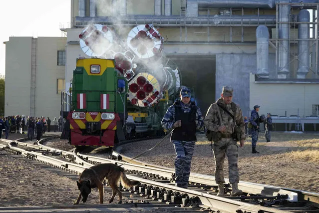 Policemen check the railway as Russia's Soyuz-2.1 booster rocket with the Soyuz MS-22 space ship that will carry new crew to the International Space Station (ISS) is transported from its hangar to the launch pad at the Russian leased Baikonur cosmodrome, Kazakhstan, Sunday, September 18, 2022. The new Soyuz mission to the International Space Station (ISS) is scheduled on Wednesday, Sept. 21 with NASA astronaut Frank Rubio, along with Roscosmos cosmonauts Sergey Prokopyev and Dmitri Petelin. (Photo by Dmitri Lovetsky/AP Photo)