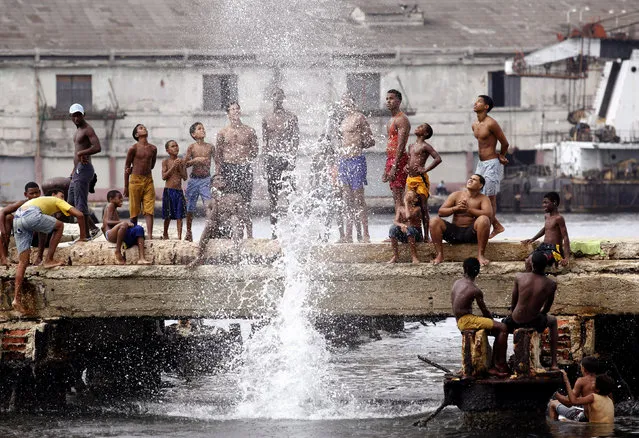 Youths compete for the highest splash as they jump into the water at Havana's port, July 2009. (Photo by Desmond Boylan/Reuters)