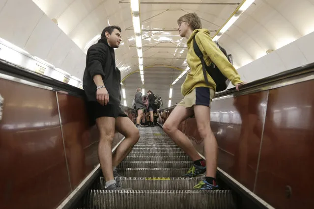 Passengers not wearing pants ride down escalators as they take part in the No Pants Subway Ride in Prague, Czech Republic, Sunday, January 10, 2016. The No Pants Subway Ride began in 2002 in New York as a stunt and has taken place in cities around the world since then. (Photo by etr David Josek/AP Photo)
