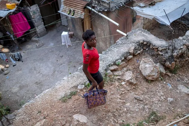 A woman walks at a neighborhood in Port-au-Prince, Haiti on July 17, 2021. (Photo by Ricardo Arduengo/Reuters)
