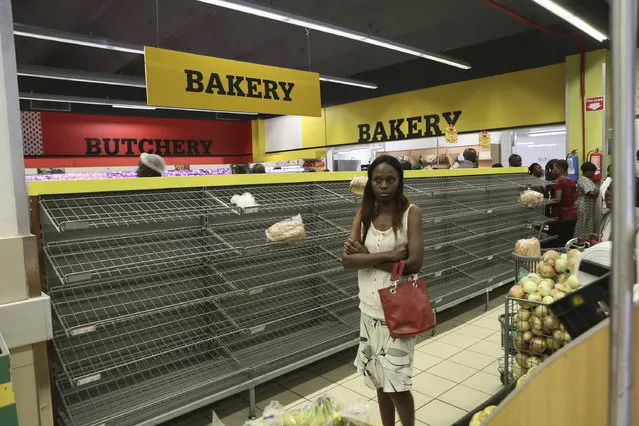 A woman walks past almost empty bread shelves in a shop in Harare, Tuesday, October 9, 2018. As Zimbabwe plunges into its worst economic crisis in a decade, gas lines are snaking for hours, prices are spiking and residents goggle as the new government insists that the country somehow has risen to middle income status. (Photo by Tsvangirayi Mukwazhi/AP Photo)