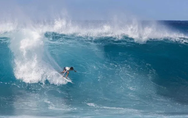 Hawaii’s Seth Moniz rides a wave on the final day of the 2023 Vans Pipeline Masters at Backdoor Pipeline on Oahu’s North shore on December 12, 2023. (Photo by Brian Bielmann/AFP Photo)