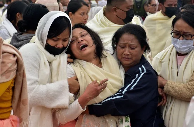 Family members of a man, who according to police, was killed during a gunfight between two unknown militant groups in a village in Manipur's Tengnoupal district, mourn outside a hospital morgue in Imphal, India on December 5, 2023. (Photo by Reuters/Stringer)