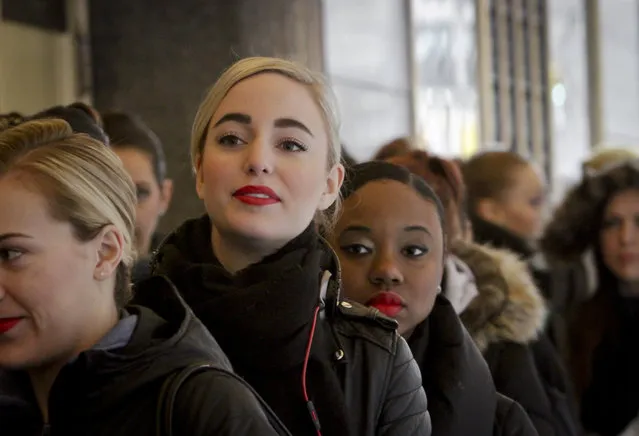 Guilia Dunes, 25, second from left, from Amsterdam and Taylor Lewis, 22, center, from Baltimore, Md., line up with other dancers outside Radio City Music Hall waiting to audition for “Rockettes New York Spectacular” on Tuesday, February 23, 2016, in New York. “I am dreaming, wishing, hoping for great things”, said Dunes and “I pray that I make it all the way through”, said Lewis, both doing a first-time Rockettes audition for a spot in the summertime production from June 15 through Aug. 7, 2016. (Photo by Bebeto Matthews/AP Photo)