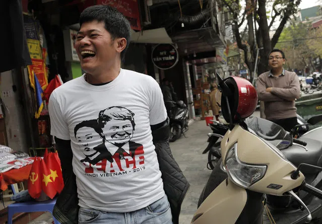 A man reacts as he wears T-shirts with portraits of U.S. President Donald Trump and North Korean leader Kim Jong Un at a tourist area in Hanoi, Vietnam Sunday, February 24, 2019. The second summit between U.S President Donald Trump and North Korean leader Kim Jong Un is scheduled in Hanoi on Feb. 27 and 28. (Photo by Vincent Yu/AP Photo)
