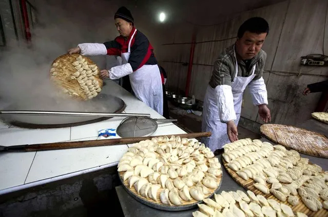 Chefs prepare to cook dumplings for a “1,000 people dumpling feast” in Liuminying village on the outskirts of BeijingFriday, January 27, 2017. Villages and cities across China are preparing this weekend to celebrate Lunar New Year, though few feasts are as elaborate as the one in Liuminying, a hamlet in Beijing's suburbs. Festivities in recent years have been more muted as China's economy has slowed down – hitting its lowest level of growth in three decades last year – and its top political leadership has issued calls for austerity. (Photo by Ng Han Guan/AP Photo)