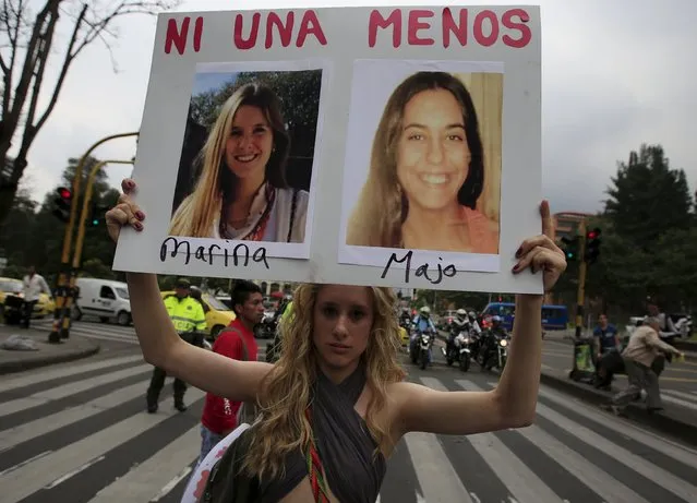A woman holds a sign during a rally called "March of Whores" to protest against discrimination and violence against women on International Women's Day in Bogota, Colombia, March 8, 2016. The sign reads "Not one more. Marina and Majo". REUTERS/John Vizcaino