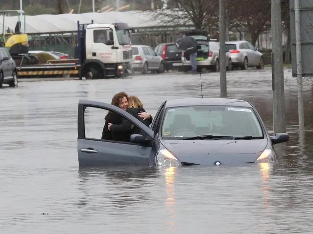 Flooding on the quay New Ross, Co.Wexford this morning. This woman being rescued by Garda Hazel Meaney, on February 1, 2014. (Photo by Mary Browne)