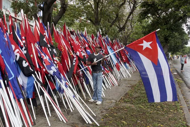 A man holds a Cuban flag after a May Day parade in Havana May 1, 2015. (Photo by Reuters/Stringer)