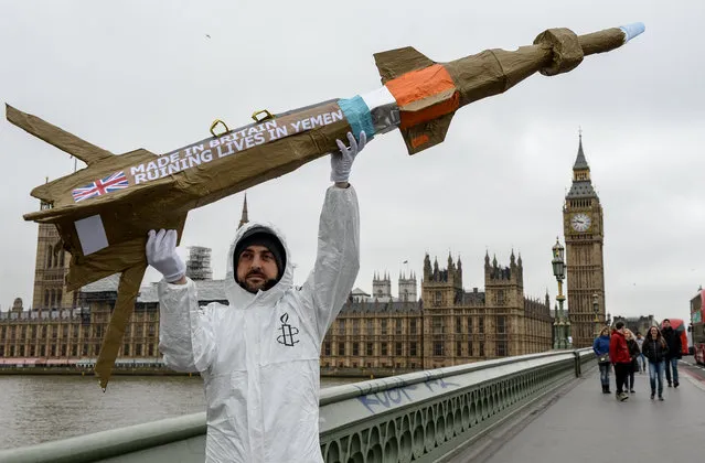 Amnesty International activists march with homemade replica missiles bearing the message 'Made in Britain, destroying lives in Yemen' across Westminster Bridge, past Parliament and to Downing Street during a protest over UK arms sales to Saudi Arabia on March 18, 2016 in London, England. The missiles are replicas of the 500lb 'Paveway-IV' weapon which are currently used by Saudi Arabia's UK supplied Eurofighter Typhoon war planes.  (Photo by Chris Ratcliffe/Getty Images)
