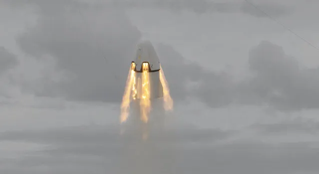 SpaceX's Dragon capsule launches, Wednesday, May 6, 2015, from Cape Canaveral, Fla. SpaceX fired the mock-up capsule to test the new, super-streamlined launch escape system for astronauts. (Photo by Red Huber/AP Photo/Orlando Sentinel)