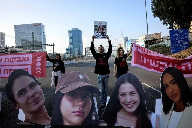 Demonstrators block the main highway as they hold signs with the faces of female hostages held in Gaza since October 7 and to call for their immediate release, amid the ongoing conflict between Israel and Palestinian Islamist group Hamas, in Tel Aviv, Israel on March 14, 2024. (Photo by Tomer Appelbaum/Reuters)