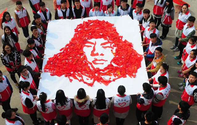 Student volunteers of Fuyang Teachers' College show a portrait of Lei Feng made with waste banners on March 6, 2016 in Fuyang, Anhui Province of China. Lei Feng is a historical hero featuring self-sacrifice, frugality and self-discipline. Lei devoted all his life to the Communist Party and the people of China. “Lei Feng spirit” is still relevant in this day and age, and Chinese people pay considerable attention to Lei Feng's Anniversary to carry forward such kinds of spirit on March 5 in each year. (Photo by ChinaFotoPress/ChinaFotoPress via Getty Images)