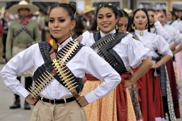 Mexican army skirmishers and dancers get ready for the ceremony and military civic parade to mark the 111th anniversary of the Mexican Revolution on November 20, 2021, an event held in Mexico City's Zócalo during the COVID-19 health emergency and the green epidemiological traffic light in the capital. (Photo by Gerardo Vieyra/NurPhoto via Getty Images)