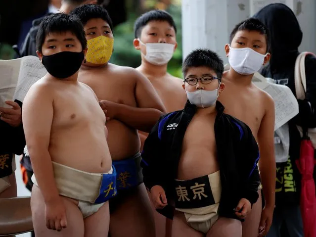 Elementary school sumo wrestlers wait for their matches during a regional tournament of Junior Olympic Cup All-Japan Elementary School Sumo Championship in Kawasaki, south of Tokyo, Japan, October 17, 2021. (Photo by Kim Kyung-Hoon/Reuters)