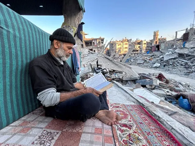 Palestinian man Ismail Al-Khlout reads the Koran as he waits to break his fast while sitting on the rubble of his house, which was destroyed during Israel's military offensive as the conflict between Israel and Hamas continues, during the holy month of Ramadan, in Beit Lahia in the northern Gaza Strip, on March 13, 2024. (Photo by Mahmoud Issa/Reuters)