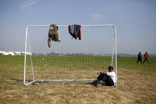 A child sits by the soccer goalpost at a makeshift camp for migrants and refugees at the Greek-Macedonian border near the village of Idomeni, Greece, March 28, 2016. (Photo by Marko Djurica/Reuters)