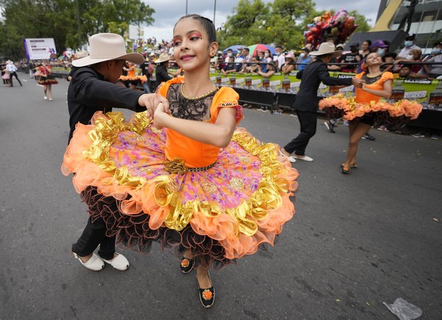 Children dance during the International Tournament of Joropo in Villavicencio, Colombia, Saturday, November 13, 2021. Joropo is the traditional music and dance of the Eastern Plains of Colombia and Venezuela. (Photo by Fernando Vergara/AP Photo)