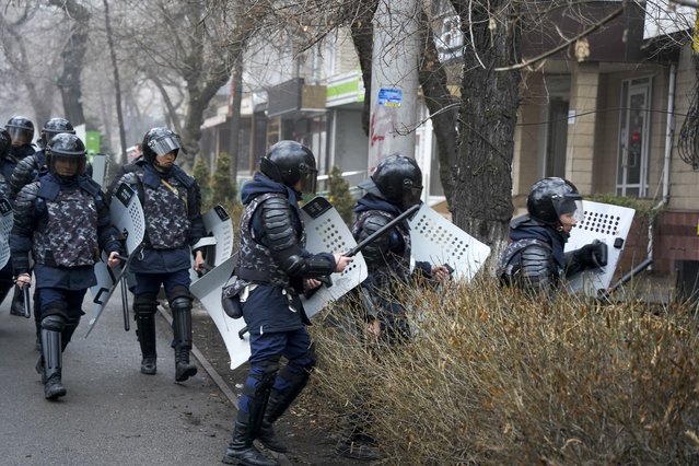 Riot police walk to block demonstrators during a protest in Almaty, Kazakhstan, Wednesday, January 5, 2022. (Photo by Vladimir Tretyakov/AP Photo)