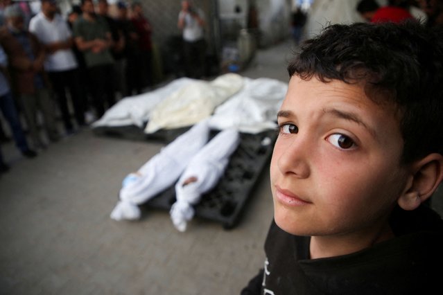 A Palestinian boy stands next to the bodies of Palestinians killed in Israeli strikes, amid the ongoing conflict between Israel and the Palestinian Islamist group Hamas, in Rafah, in the southern Gaza Strip, on April 25, 2024. (Photo by Hatem Khaled/Reuters)