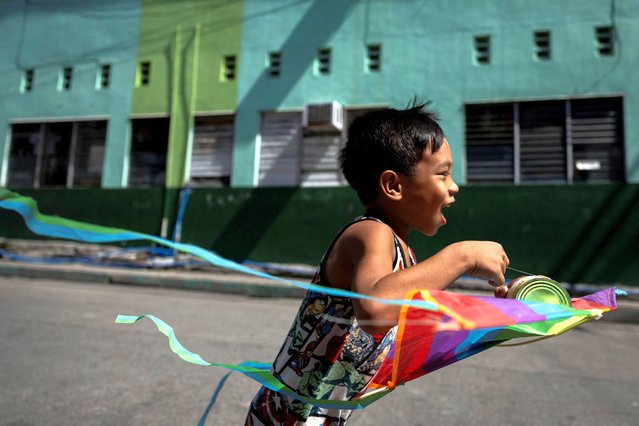 A boy runs with a kite in Valenzuela, Metro Manila, Philippines, on May 2, 2024. (Photo by Eloisa Lopez/Reuters)