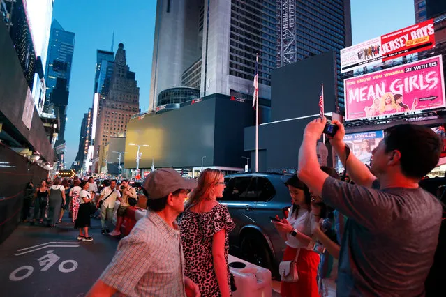 Screens in Times Square are black during a widespread power outage, Saturday, July 13, 2019, in New York. Authorities say a transformer fire caused a power outage in Manhattan and left businesses without electricity, elevators stuck and subway cars stalled. (Photo by Michael Owens/AP Photo)