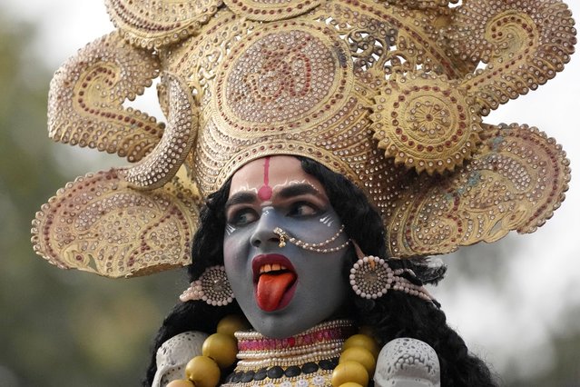 A devotee dressed as Hindu goddess Kali participates in a procession on the eve of Shivratri festival in Jammu, India, Friday, February 17, 2023. The festival dedicated to the worship of Shiva, will be marked across the country on Saturday. (Photo by Channi Anand/AP Photo)