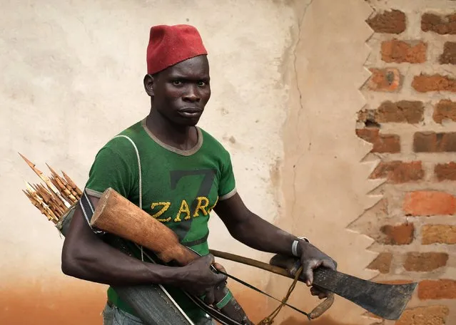 A member of the anti-balaka, a Christian militia, walks with his weapons in village of Zawa April 8, 2014. (Photo by Goran Tomasevic/Reuters)