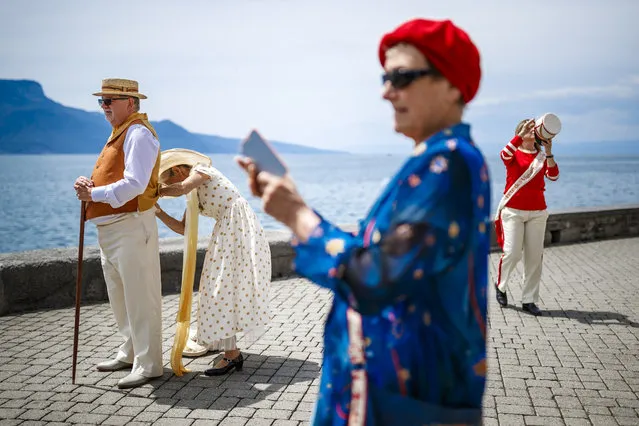 Extras of the “Fete des Vignerons” (winegrowers' festival) prepare for the official opening parade prior to the first representation and crowning ceremony in Vevey, Switzerland, 18 July 2019. (Photo by Valentin Flauraud/EPA/EFE)