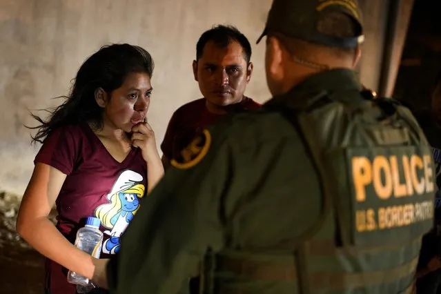 Thirteen-year-old Joseline, a Guatemalan migrant seeking asylum with father Jose Luis, cries after crossing the Rio Grande and turning herself into U.S. Border Patrol in Hidalgo, Texas, August 23, 2019. (Photo by Loren Elliott/Reuters)