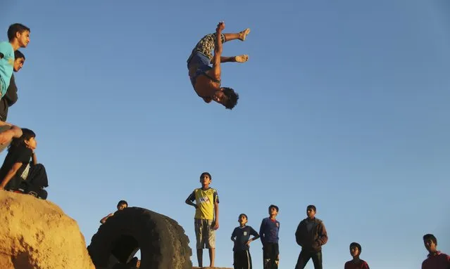 A Palestinian youth practices his parkour skills at Shati refugee camp in Gaza City April 27, 2014. (Photo by Mohammed Salem/Reuters)