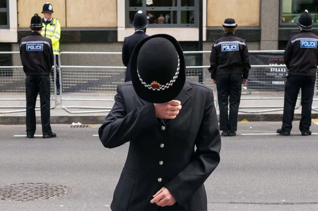 A Police officer wipes away tears whilst lining the route of the funeral cortege of PC Keith Palmer Southwalk Street on April 10, 2017 in London, United Kingdom. A Full Force funeral is held for PC Keith Palmer who was killed in a terrorist attack in Westminster whilst on duty on March 22, 2017. The funeral is attended by his family, including his wife and child, and officers from the Metropolitan Police who served alongside him. Officers from the wider service across England and Wales also attend to honour their fallen colleague. (Photo by Ian Gavan/Getty Images)