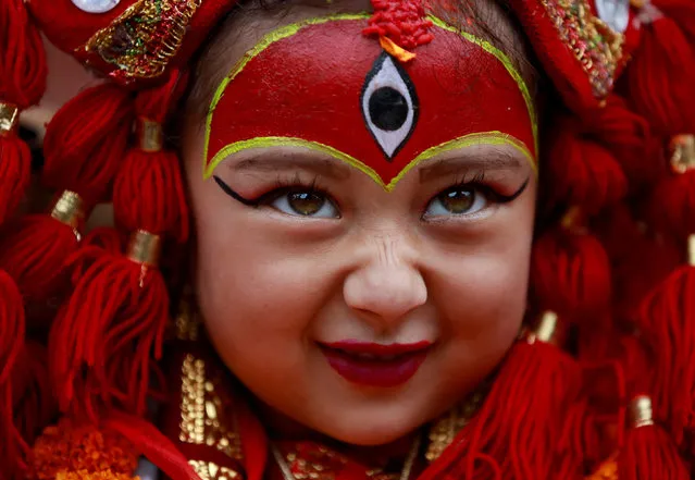 A young girl dressed as the Living Goddess Kumari participates the Kumari Puja festival, in which young girls pose as the Living Goddess Kumari and are worshipped by people in belief that their children will remain healthy, in Kathmandu, Nepal on September 11, 2019. (Photo by Navesh Chitrakar/Reuters)