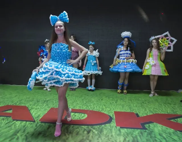 Models present outfits made with air balloons during an international festival of air balloons design in Almaty, Kazakhstan, July 9, 2015. (Photo by Shamil Zhumatov/Reuters)