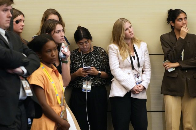 Staff members and others listen as President Joe Biden speaks at a news conference on the final day of the NATO summit in Washington, July 11, 2024. (Photo by Jacquelyn Martin/AP Photo)