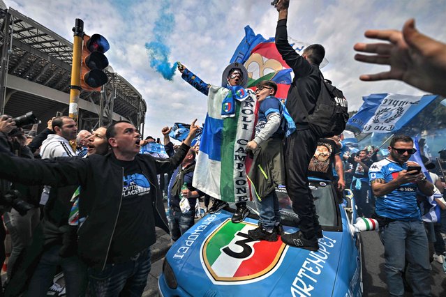 Napoli supporters cheer with colorful smoke and team flags as they assemble outside the Diego-Maradona stadium in Naples, on April 30, 2023, prior to the Italian Serie A football match between Napoli and Salernitana. Naples braces for its potential first Scudetto championship win in 33 years. With a 17 point lead at the top of Serie A, southern Italy's biggest club is anticipating its victory in the Scudetto for the first time since 1990. (Photo by Filippo Monteforte/AFP Photo)