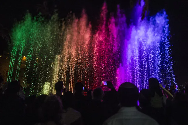 People watch the Light Festival on May 26, 2016 in Jerusalem, Israel. The Light Festival, which features both Israeli and international artists, takes place annually in Jerusalem's Old City and the surrounding areas. (Photo by Ilia Yefimovich/Getty Images)