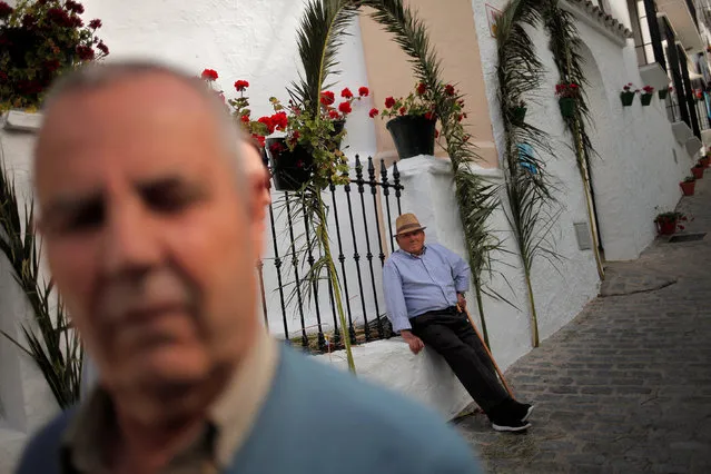 A man sits on a decorated street during Corpus Christi day in El Gastor, southern Spain, May 29, 2016. (Photo by Jon Nazca/Reuters)