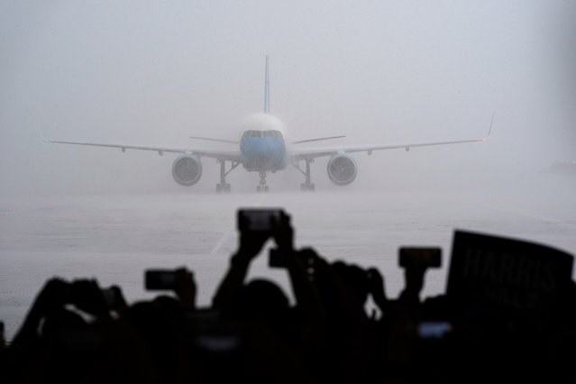 Supporters look on as Air Force Two with Democratic presidential nominee Vice President Kamala Harris on board lands at Pittsburgh International Airport, Sunday, August 18, 2024, in Pittsburgh. (Photo by Julia Nikhinson/AP Photo)