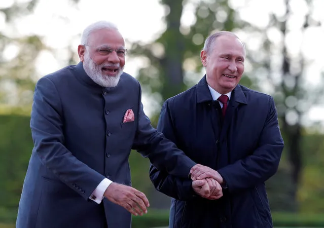 Russian President Vladimir Putin (R) and Indian Prime Minister Narendra Modi react while walking near the Constantine (Konstantinovsky) Palace during their meeting in St. Petersburg, Russia, June 1, 2017. (Photo by Mikhail Metzel/ReutersTASS/Host Photo Agency)
